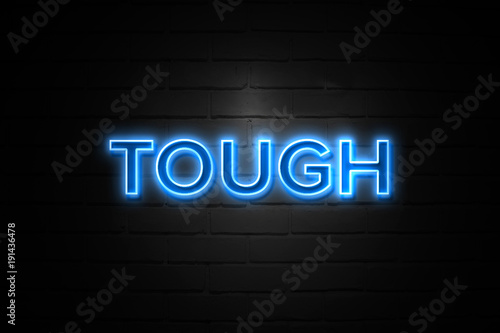 Photo  Tough neon Sign on brickwall