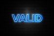 © zobaair - Valid neon Sign on brickwall