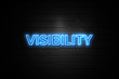 Visibility neon Sign on brickwall