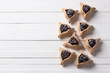 Traditional sweets for the Jewish holiday Purim. Hamantashen cookies or ears of Haman, triangular cookies with poppy seeds and raisins on a white background, top view, free space