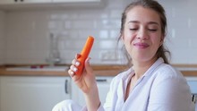 Healthy Beautiful Woman Tasting And Eating A Carrot