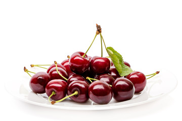 Wall Mural - Cherry berries on a white plate isolated on white background cutout