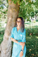 Poster - Beautiful woman resting in summer park.