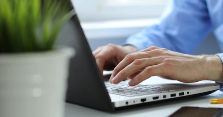 businessman typing on laptop keyboard working in office