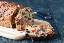 Traditional stollen fruit cake sliced on table
