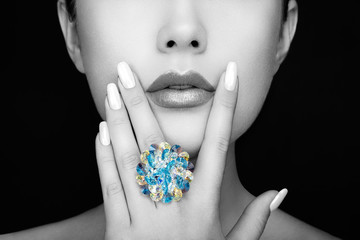 Wall Mural - Beauty Fashion Woman lips with natural Makeup and white Nail polish. Gloss Lipstick. Beauty girl face close up. Sexy Lips, Manicure, Make up. Ring with Precious Stones, Jewelry