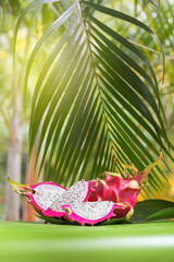 Wall Mural - Fresh, tasty tropic, exotic dragon pitahya dragon fruit near palms