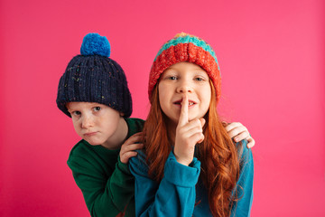 Wall Mural - Little children isolated showing silence gesture.