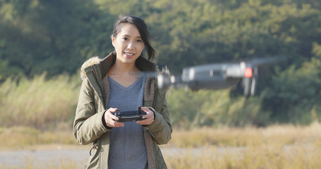 Wall Mural - Woman control flying drone