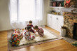 © RooM The Agency - Three children sitting on the floor playing a board game