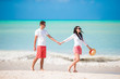 © travnikovstudio - Young couple on white beach. Happy family on honeymoon vacation