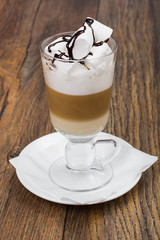 Sticker - Tall glass with latte and marshmallow on wooden table