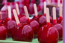 Sweet Glazed Red Candy Apples On Sticks For Sale On Local Market. Kids Treat Concept