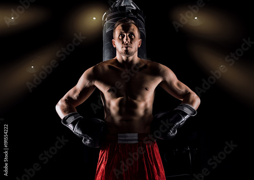 Leinwand Poster Professional sportsman of mixed martial arts stands after the fight won near the