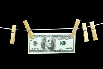 dollars banknotes on a clothesline concept money laundering Black background