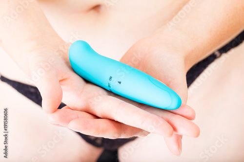 Fotografia, Obraz blue vibrator and measuring tape in a female hands before her abdomen