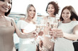 © zinkevych - Sparkling wine. Selective focus of glasses with champagne being held by positive attractive young women while having a celebration