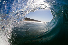 Inside View Of Wave Breaking With Tropical Island View In Background