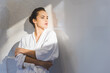© LIGHTFIELD STUDIOS - portrait of beautiful pensive woman in bathrobe looking away at home
