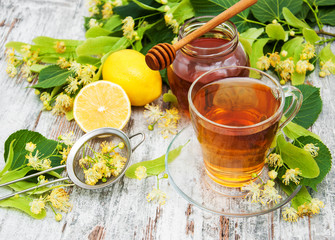 Wall Mural - cup of herbal tea with linden flowers