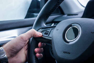 hand on a control buttons steering wheel