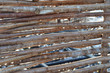 Close-up of a fence texture made of wooden rods in the sunlight