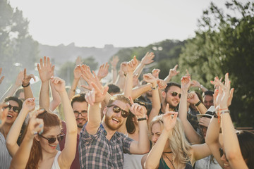 Group of people dancing and having a good time at the outdoor party/music festival 