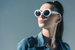 © LIGHTFIELD STUDIOS - beautiful stylish woman in denim clothes and sunglasses, isolated on grey