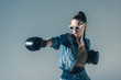 © LIGHTFIELD STUDIOS - stylish boxing girl in denim clothes and sunglasses, isolated on grey