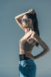 © LIGHTFIELD STUDIOS - beautiful girl posing in sunglasses with ponytail hairstyle, isolated on grey