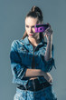 © LIGHTFIELD STUDIOS - brunette girl posing in denim clothes with retro camera, isolated on grey