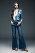 © LIGHTFIELD STUDIOS - beautiful girl with long hair posing in scarf, flare jeans and denim shirt, on grey