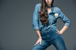 © LIGHTFIELD STUDIOS - cropped view of girl posing in denim shirt with flower, isolated on grey