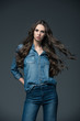 © LIGHTFIELD STUDIOS - attractive girl with long hair posing in jeans, isolated on grey
