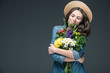 © LIGHTFIELD STUDIOS - beautiful happy woman with closed eyes holding flowers for 8 march, isolated on grey