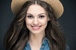 © LIGHTFIELD STUDIOS - attractive smiling girl with long hair in straw hat, isolated on grey