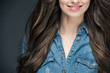 © LIGHTFIELD STUDIOS - cropped view of smiling brunette girl with long hair, isolated on grey