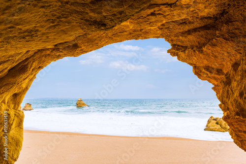 View to the sea beach from inside a cave