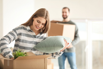 Poster - Young couple packing their belongings indoors. Moving day