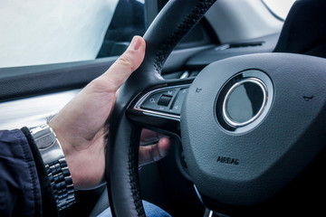 hand holding steering wheel