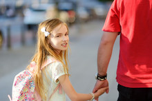 Cute Little Girl Holding Hand Of Her Father During Summer City Walk.