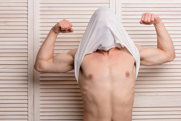 Guy with strong muscles in white tank top.