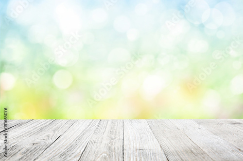 Wooden deck with blurred flower garden background