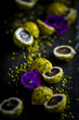 pistachio and cheese coated grapes  with flower decoration on black slate plate 