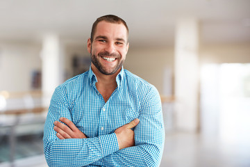 smiling man standing in business center