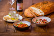 assorted salads in mediterranean restaurant  with focaccia bread in background on wooden table