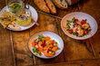 mediterranean food on wooden table, salmon salad and mezze