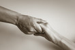 © kieferpix - Hand holding up hand. Giving blessing and help.