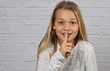 © dream@do - Portrait of happy smiling 10 years old kid girl showing silence gesture