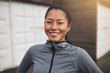 © Flamingo Images - Smiling young Asian woman in sportswear out for a run